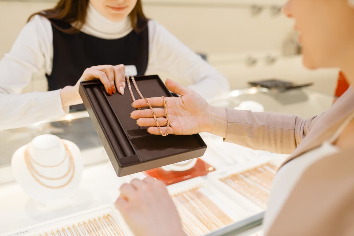 Modern jewelry retail store interior with display cases and jewelry professionals